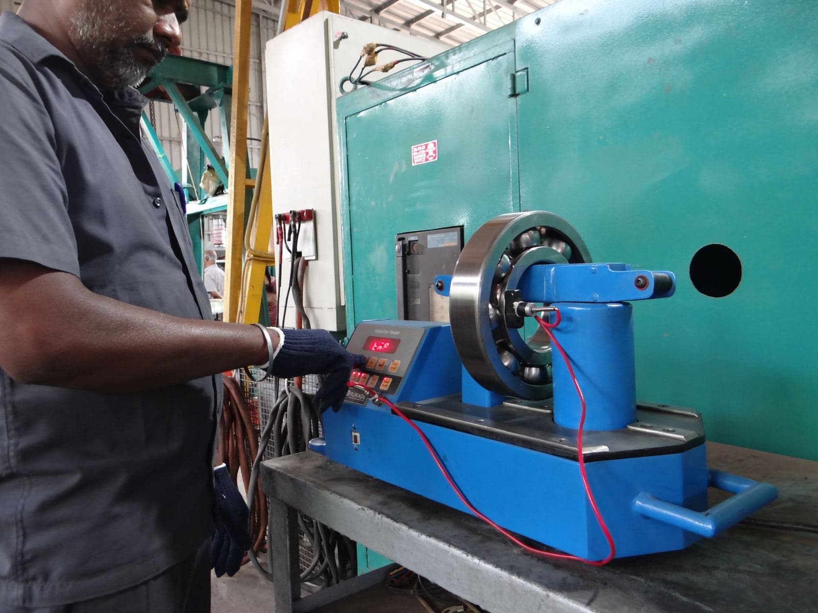Our technician heating up a bearing using induction heater